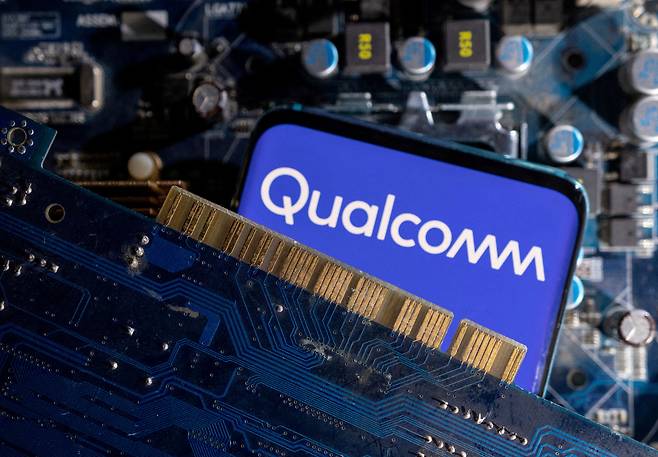 A smartphone with a displayed Qualcomm logo is placed on a computer motherboard in this illustration. Qualcomm, a leading maker of wireless chips, joins the San Diego trade delegation to Seoul.