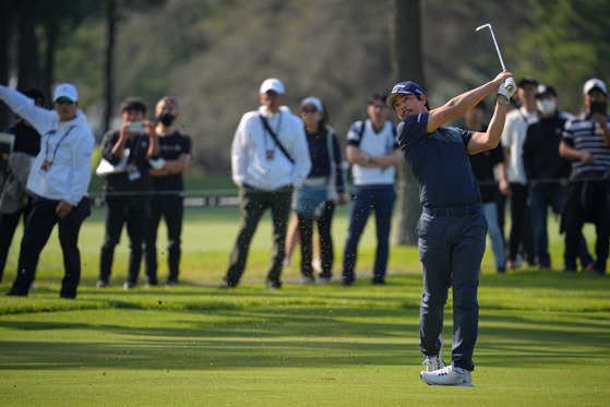 Ryo Ishikawa hits his second shot on the 11th hole during the first round of the Zozo Championship at Accordia Golf Narashino Country Club in Inzai, Japan on Oct. 19.  [GETTY IMAGES]