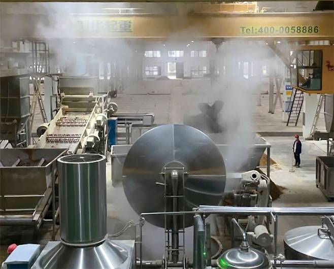 10월 17일 중국 산시성 바오지 서봉주 공장에서 크레인과 근로자들이 증류 작업을 하고 있다. 사진 양범수 기자