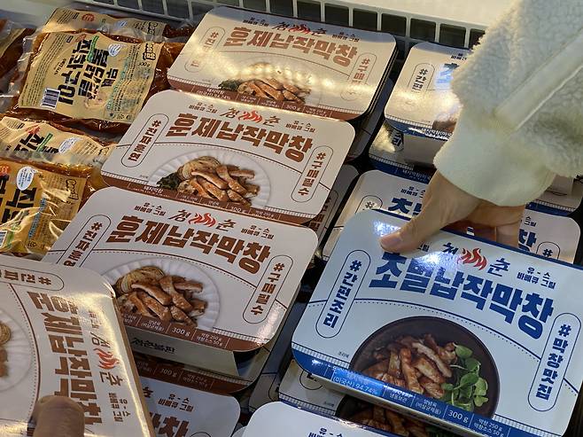 A visitor picks up a makchang, or beef intestine, meal kit from Cheongchun Bulpan, at 2023 Coex Food Week, held at Coex in southern Seoul, Wednesday. (Hwang Joo-young/The Korea Herald)