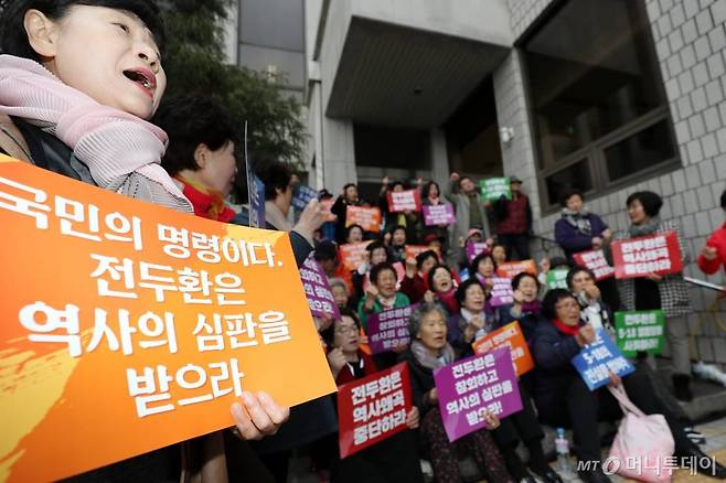 사자명예훼손 혐의를 받고 있는 전두환(87) 전 대통령이 광주법정에 출석한 11일 오후 광주법원 앞에서 오월어머니회 회원들이 피켓을 들고 '전두환씨 구속'을 촉구하고 있다. 전씨는 지난 2017년 4월 펴낸 회고록에서 5·18 피해자인 고(故) 조비오 신부의 헬기 사격 목격 증언이 거짓이라고 주장하며, 조 신부를 거짓말쟁이라고 비난하고 명예를 훼손한 혐의로 기소돼 5·18 피고인 신분으로 23년 만에 다시 법정에 선다. /사진=광주=홍봉진 기자