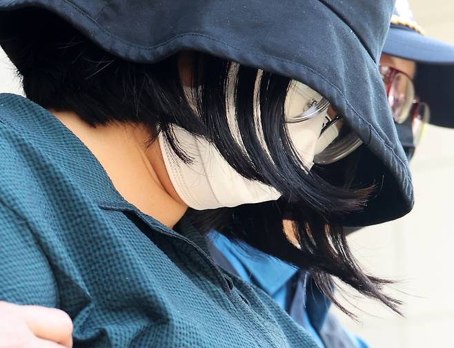 Murder convict Jung Yoo-jung leaves a police detention center to the prosecution in Busan on June 2. (Yonhap)