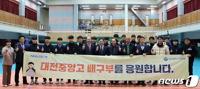 이재윤 NH농협은행 대전본부장(앞줄 오른쪽 일곱번째)이 중앙고에 체육발전기금을 기탁한 후 학교 관계자 및 배구부 선수등과 기념사진을 찍고 있다.( NH농협은행 대전본부 제공)/뉴스1