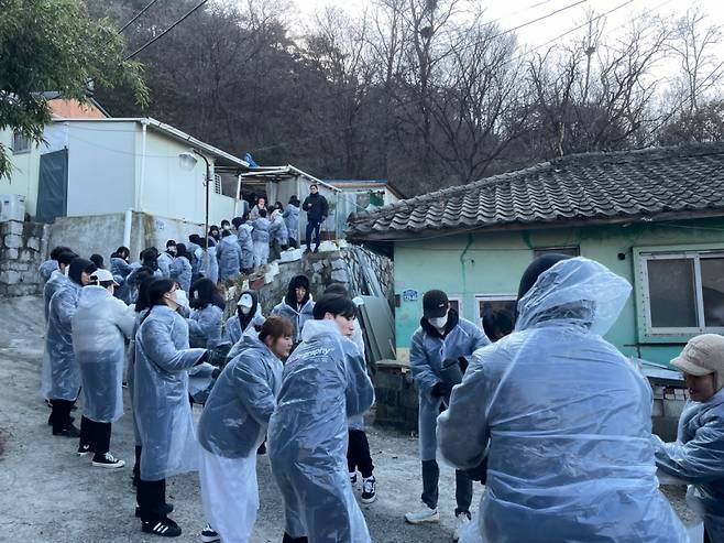 상명대 학생들이 홍제동 개미마을에 연탄을 전달하고 있다./사진제공=상명대