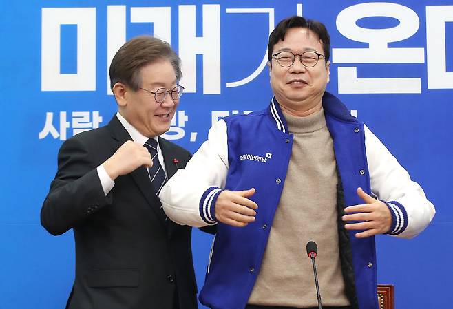 이재명 더불어민주당 대표가 14일 오전 서울 여의도 국회에서 더불어민주당 인재영입 2호 인사인 이재성 세솔테크 고문에게 당 점퍼를 입혀주고 있다. /뉴스1
