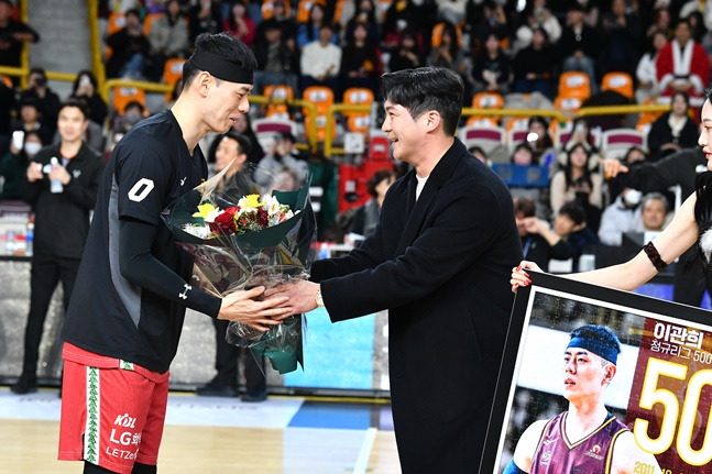 LG 트윈스 오지환(오른쪽)이 24일 창원실내체육관에서 열린 창원 LG와 부산 KCC의 2023~2024 정관장 프로농구 경기를 방문해 통산 500경기에 출전한 창원 LG 이관희에게 꽃다발을 전달하고 있다. /사진=KBL