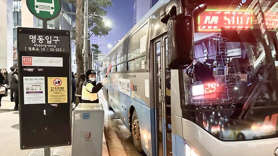 10일 저녁 7시경 서울 중구 명동 입구 광역버스 정류장에서 계도요원이 차량 혼잡을 막기 위해 수신호를 보내고 있다. 문희철 기자