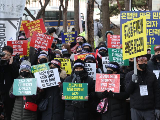 홍콩H지수 주가연계증권(ELS) 피해자모임이 19일 오후 서울 영등포구 여의도 금융감독원 앞에서 손팻말을 들고 보상을 촉구하고 있다. 뉴스1