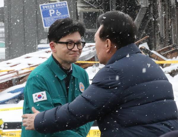 윤석열 대통령(오른쪽)이 23일 충남 서천군 서천읍 서천특화시장 화재 현장에서 국민의힘 한동훈 비상대책위원장과 만나 인사하고 있다. 연합뉴스