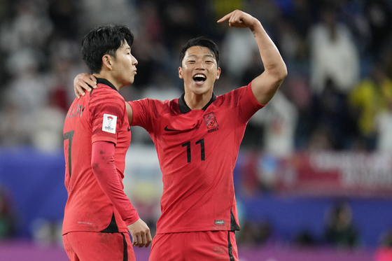 Korea's Son Heung-min, left, celebrates with Hwang Hee-chan after scoring his side's second goal during an Asian Cup quarterfinal against Australia  [AP/YONHAP]