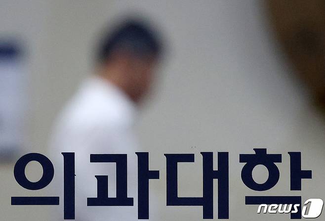 (서울=뉴스1) 장수영 기자 = 19일 오전 서울의 한 의과대학 출입문으로 관계자가 지나가고 있다.    대한의과대학·의학전문대학원학생협회(의대협)는 정부의 의대 증원 방침에 반발해 오는 20일부터 동맹 휴학을 결의한 상태다. 2024.2.19/뉴스1  Copyright (C) 뉴스1. All rights reserved. 무단 전재 및 재배포,  AI학습 이용 금지.