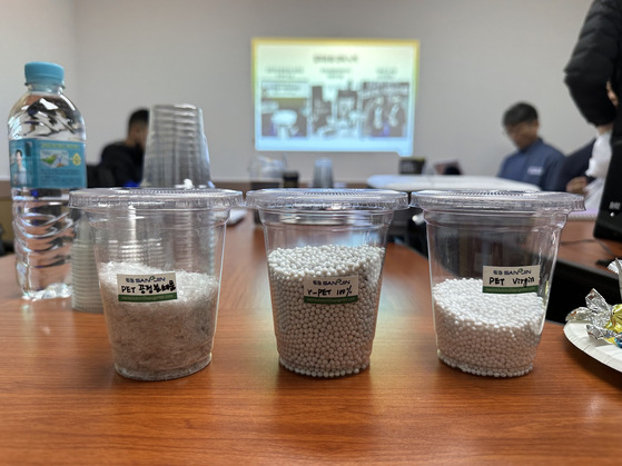 The recycled plastic chips, center, which are transformed into plastic cups and lids for McDonald's sundae ice cream. [SEO JI-EUN]