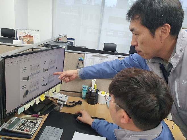 이호성 수석(오른쪽)과 이원석 책임이 코팅 덕트 신제품 개발을 위해 논의하고 있다. 윤현주 기자