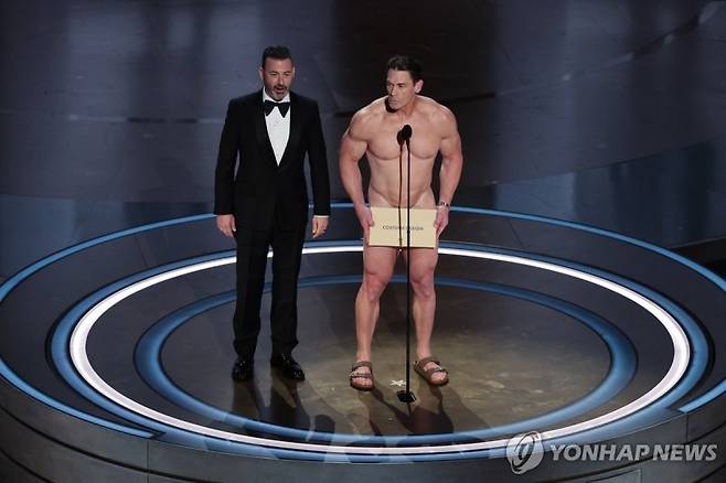John Cena performs on stage with host Jimmy Kimmel during the presentation of the Oscar for Costume Design on stage during the Oscars show at the 96th Academy Awards in Hollywood, Los Angeles, California, U.S., March 10, 2024. REUTERS/Mike Blake