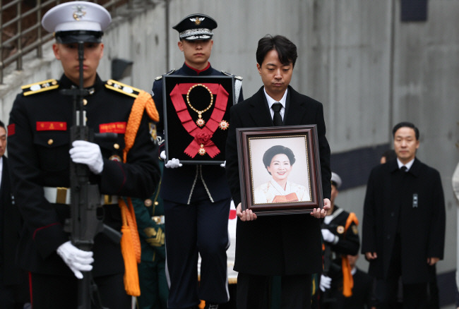 11일 오전 서울 종로구 서울대병원 장례식장에서 김영삼 전 대통령의 부인 고 손명순 여사의 발인이 엄수된 가운데 김 전 대통령 장손인 김성민(왼쪽에서 세 번째) 씨가 여사의 영정 사진을 들고 걸어가고 있다.  연합뉴스