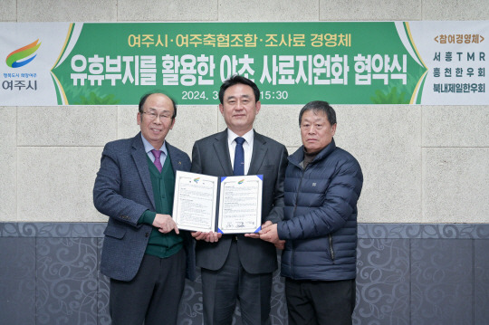 지난 8일 경기 여주시청에서 이충우(가운데) 여주시장과 축산업 관계자들이 ‘유휴부지를 활용한 야초 사료자원화 협약식’에서 협약서를 들어보이고 있다. 여주시청 제공