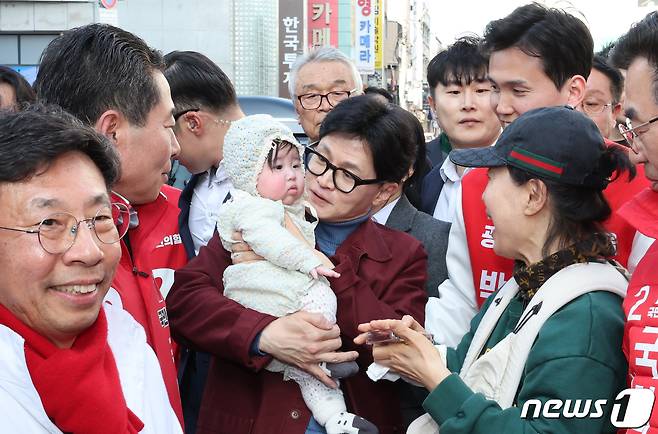 한동훈 국민의힘 비상대책위원장이 15일 광주 동구 충장로에서 아이를 안고 기념 촬영을 하고 있다. 2024.3.15/뉴스1 ⓒ News1 김태성 기자