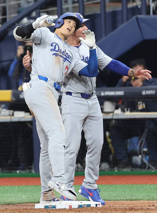 <yonhap photo-4839="">20일 오후 서울 고척스카이돔에서 미국프로야구(MLB) 공식 개막전 LA다저스 대 샌디에이고 파드리스 1차전 경기. 8회초 1사 1,2루 때 LA 다저스 오타니 쇼헤이가 1타점 적시타를 친 후 기뻐하고 있다. [연합뉴스]</yonhap>