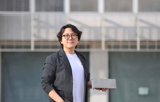 파네시아 창업자 정명수 카이스트 교수가 대전 교수연구실 앞에서 CXL이 탑재된 AI 가속 반도체를 들고 있다. 프리랜서 김성태