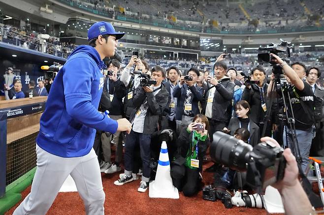 오타니 쇼헤이가 지난 20일 샌디에이고와 개막전에 앞서 취재진이 기다리는 가운데 몸을 풀러 그라운드에 나서고 있다. AP연합뉴스