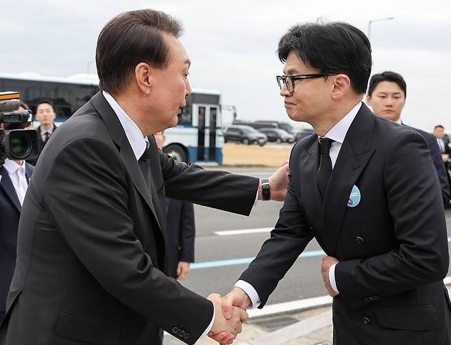 윤석열 대통령이 지난 22일 경기도 평택 소재 해군 제2함대사령부에서 거행된 제9회 서해수호의날 기념식 행사를 마친 뒤 헤어지며 국민의힘 한동훈 비상대책위원장의 어깨를 두드려 주며 악수하고 있다. [대통령실 제공] 연합뉴스