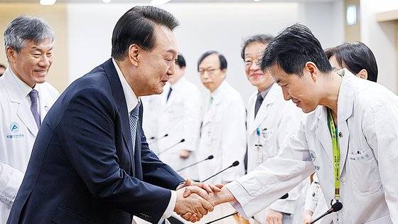 윤석열 대통령이 지난 18일 서울 송파구 서울아산병원을 방문해 간담회에 참석한 의료진과 인사하고 있다.연합뉴스