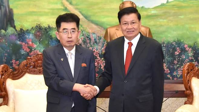 김성남 북한 국제부장(왼쪽)과 통룬 시술릿 라오스 주석 [조선중앙통신]