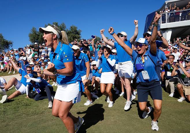 24일(현지 시각) 스페인에서 열린 솔하임컵 골프대회 마지막날 싱글매치에서 유럽팀 시간다가 미국팀 넬리 코다를 이기며 유럽팀 승리를 확정짓자 유럽팀 선수들이 환호하며 뛰어 나가고 있다./AP 연합뉴스