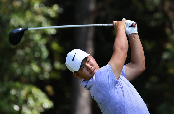 Tom Kim hits his tee shot on the 11th hole during a practice round ahead of the Masters at Augusta National Golf Club in Augusta, Georgia on Monday.  [REUTERS/YONHAP]