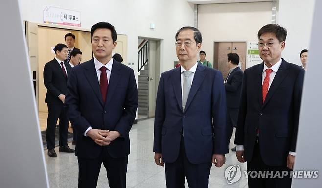 총선 하루 앞으로, 투표소 점검 나선 한덕수 총리 (서울=연합뉴스) 황광모 기자 = 22대 국회의원 선거 본투표를 하루 앞둔 9일 오후 한덕수 국무총리가 서울 종로1.2.3.4가동 행정복지센터에 마련된 투표소를 찾아 오세훈 서울시장의 현황보고를 듣고 있다. 2024.4.9 hkmpooh@yna.co.kr