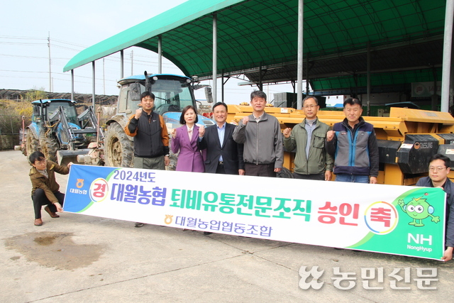 지인구 대월농협 조합장(서있는 사람 왼쪽서 세번째)과 직원들이 퇴비유통전문조직 선정을 축하하며 농가에 양질의 퇴비를 공급할 것을 다짐하고 있다.