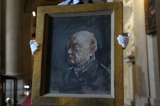 소더비 직원이 16일(현지시간) 영국 화가 그레이엄 서덜랜드가 1954년 그린 윈스턴 처칠 전 영국 총리의 초상화를 들고 포즈를 취하고 있다. 초상화는 오는 6월 6일 경매에 오를 예정이며 예상 가격은 50~80만파운드다. AP 뉴시스