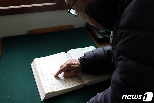 국군포로 유가족 이강복 씨가 충남 서산의 자택에서 북한으로 끌려간 가족들의 이름이 적힌 족보를 들춰보고 있다. 2023.12.26/뉴스1 ⓒ News1 박동해 기자