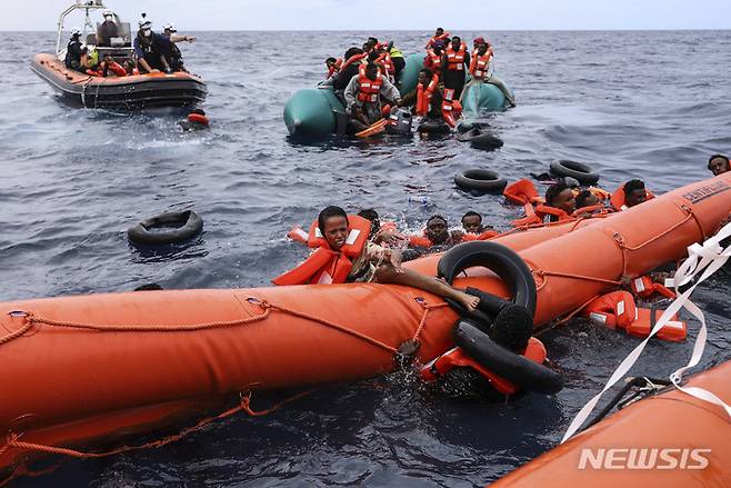 [리비아해역=AP/뉴시스] 리비아 해안에서56km떨어진 지중해에서 고무보트를 타고 유럽을 향해 가다가 조난한 난민들이 리비아 해양경찰에 의해 구조되는 광경( 2021년 10월 18일 AP자료사진). 2024.04. 23.