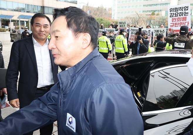 A construction union protests against Minister of Land, Infrastructure, Transport and Tourism Won Hee-ryong with a picket as he leaves after attending a testimony session on illegal unfair practices of construction site unions at the Professional Construction Hall in Dongjak-gu, Seoul, on March 8, last year. Yonhap News Agency