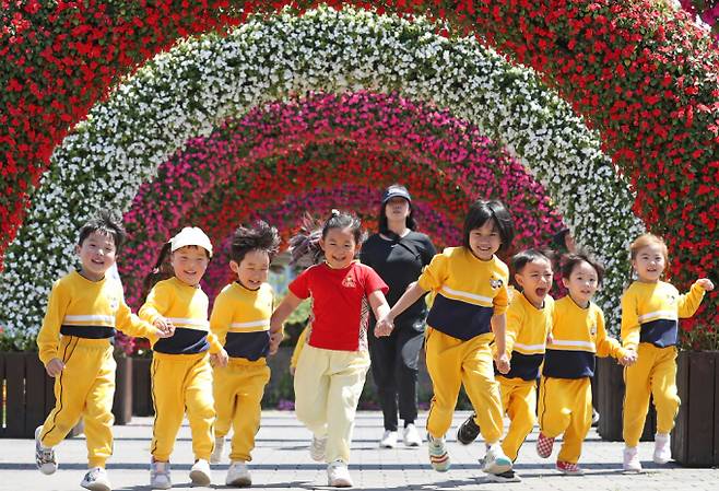 어린이날을 이틀 앞둔 3일 오후 제4회 부산 봄꽃 전시회가 열리고 있는 부산시민공원을 찾은 어린이들이 꽃터널을 지나며 환하게 웃고 있다./사진=뉴스1