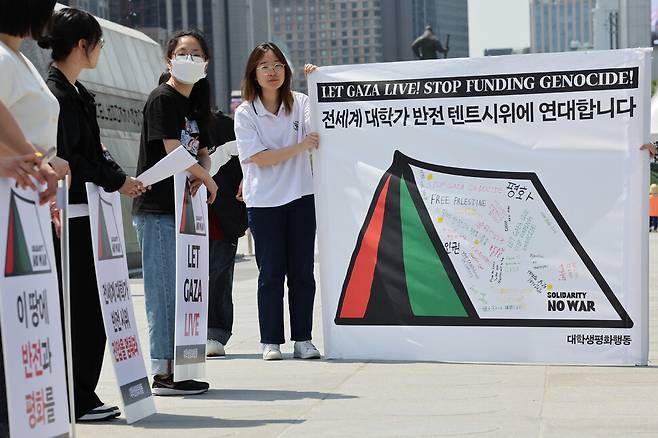팔레스타인 국기 색깔의 텐트가 그려진 펼침막에 한국어, 영어, 일본어, 중국어 등 다양한 언어로 반전 메시지가 적혀 있다. 김영원 기자