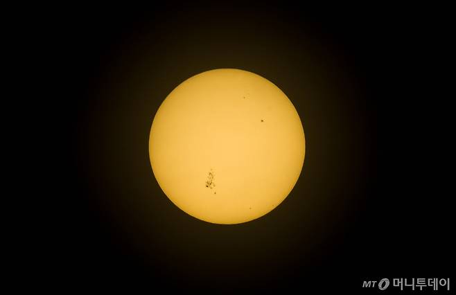 [제주=뉴시스] 우장호 기자 = 올해부터 11년 주기로 태양 활동이 강력해지는 극대기가 시작되면서 거대한 '태양 흑점'이 자주 나타나고 있다. 흑점은 태양의 주변 영역보다 온도가 낮아 강한 자기 활동을 보이는데, 이로 인해 극대기에는 태양플레어 등 지구 대기권까지 영향을 미치는 현상이 강해진다.    9일 오후 제주시에서 바라본 태양에서 커다란 흑점 여러개가 관측됐다. 태양 표면에 검게 보이는 부분이 흑점이다. 2024.05.09. / 사진제공=뉴시스