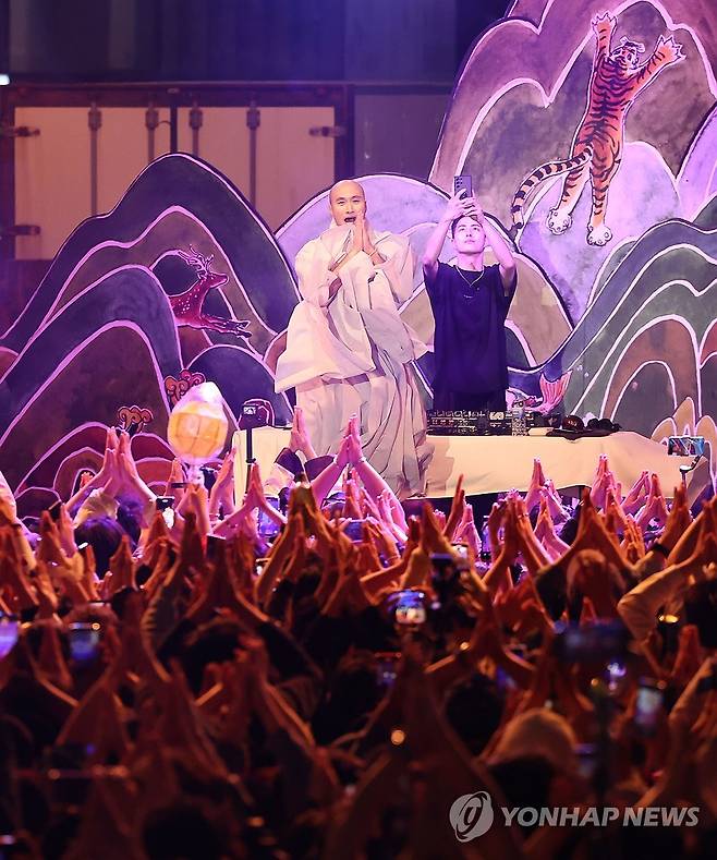 부처핸섬 '뉴진스님' (서울=연합뉴스) 윤동진 기자 = 12일 서울 조계사앞사거리에 설치된 무대에서 열린 'EDM(일렉트로닉 댄스 뮤직) 난장'에서 '뉴진스님'으로 활동하는 개그맨 윤성호가 디제이로 나서 신나는 무대를 선보이고 있다. 2024.5.12 mon@yna.co.kr