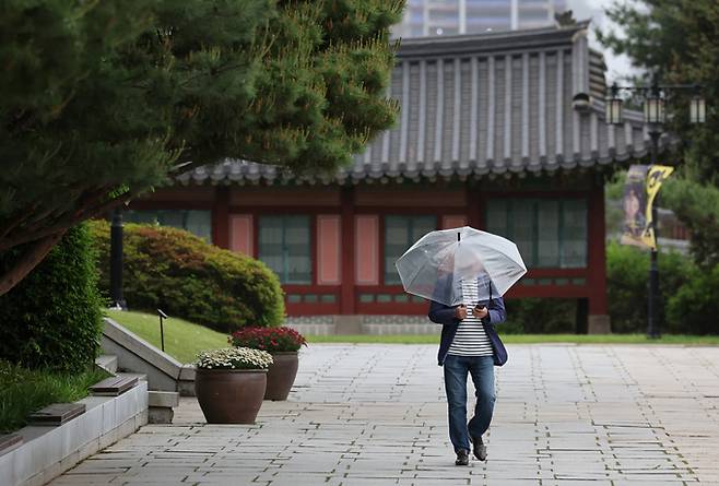 수도권 지역에 비가 내리는 15일 오후 서울 종로구 국립민속박물관에서 우산을 쓴 관람객들이 발걸음을 옮기고 있다.  뉴스1