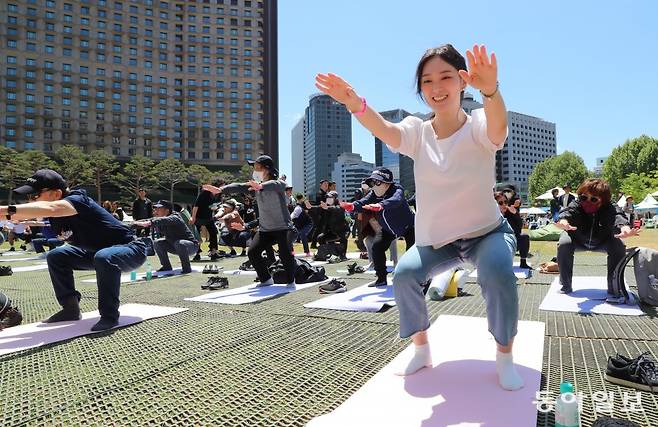 운동은 힘들어도 즐겁고 행복해요. 스쿼트 자세를 훈련하는 참가자.