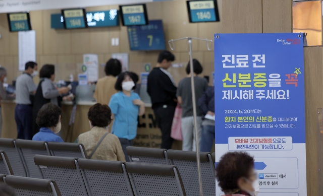 병·의원에서 건강보험 급여가 적용되는 진료를 받을 때 반드시 신분증 등을 지참해 본인 확인 절차를 거쳐야 한다는 내용의 개정 국민건강보험법 시행 날인 20일 대구 한 대학병원에 건강보험 진료 시 본인 여부 확인 안내문이 붙어있다. 연합뉴스.