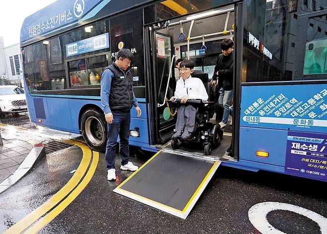 오영진 위즈온협동조합 이사가 저상버스에서 하차하고 있다. 대전에서는’위버스(webus)’ 애플리케이션으로 저상버스를 예약하면 알림을 받은 버스기사가휠체어 장애인의 승하차를 돕는다. /행복나눔재단 제공