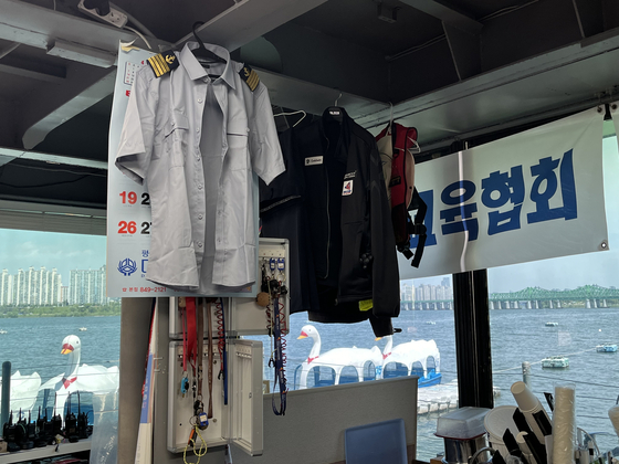 Shirts hang in the office decked out in boat-related gear and other various goodies. [MARY YANG]