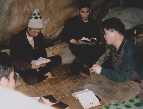 박용배(오른쪽) 목사가 중국과 북한의 접경 지역 산속 움막에 숨어 생활하는 탈북민에게 구호물자와 성경책을 전달하고 함께 예배드리고 있다.