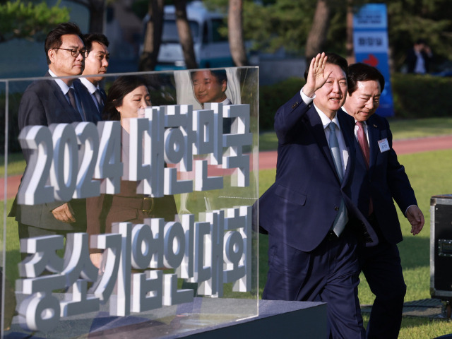 윤석열 대통령이 23일 서울 용산 대통령실 잔디마당에서 열린 '2024 대한민국 중소기업인대회'에 입장하며 손 흔들어 인사하고 있다. 연합뉴스