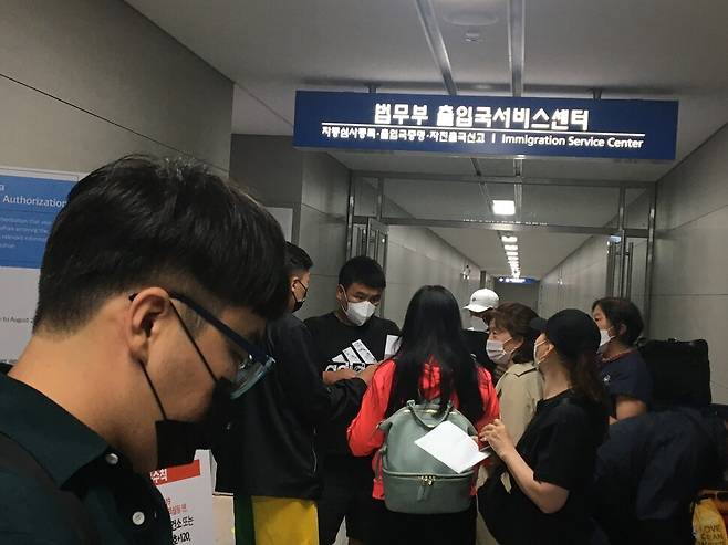 2021년 7월15일 인천공항 법무부 출입국서비스센터 앞에 선 김호준씨가 출국확인서를 받기 위해 기다리는 몽골인들 사이에서 순서를 기다리고 있다. 이문영 기자