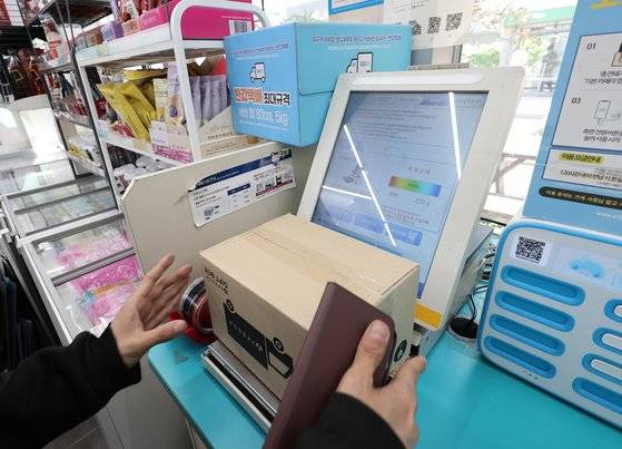 최근 편의점은 제품 판매를 넘어 택배 등 오프라인 플랫폼으로서 기능을 확대하고 있다. 사진은 서울 시내 한 편의점에서 시민이 택배를 접수하는 모습. 뉴스1