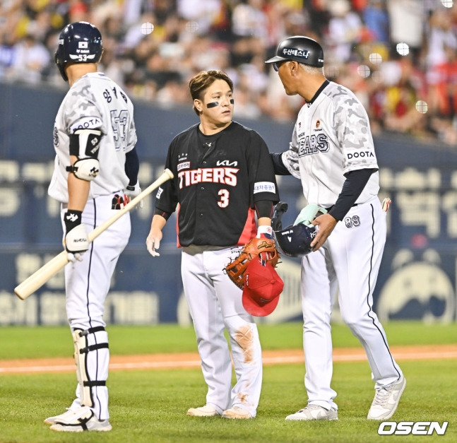 KIA 김선빈(가운데)이 8일 잠실 두산전 7회 말 이닝 교대 때 양석환(왼쪽)과 코치에게 라모스에 대한 불만을 이야기하고 있다.