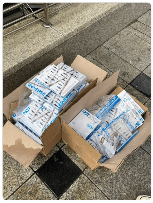 NCT albums are seen discarded near Myeongdong Station, Seoul in 2021. The poster noted that the albums did not contain any photo cards, which appear to have been removed by the purchaser before discarding the albums. (Screenshot from X)